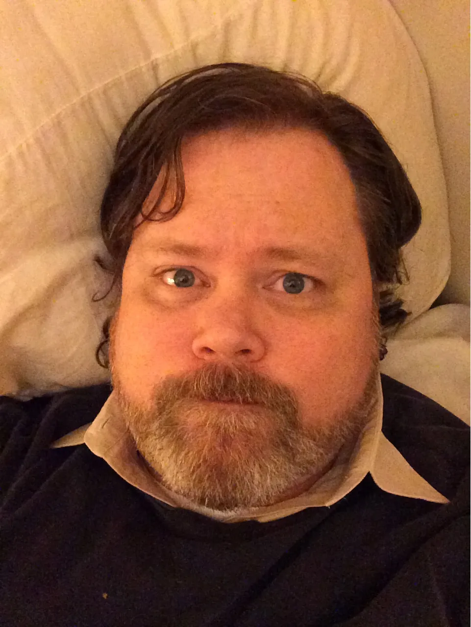 John Stansbury on a bed